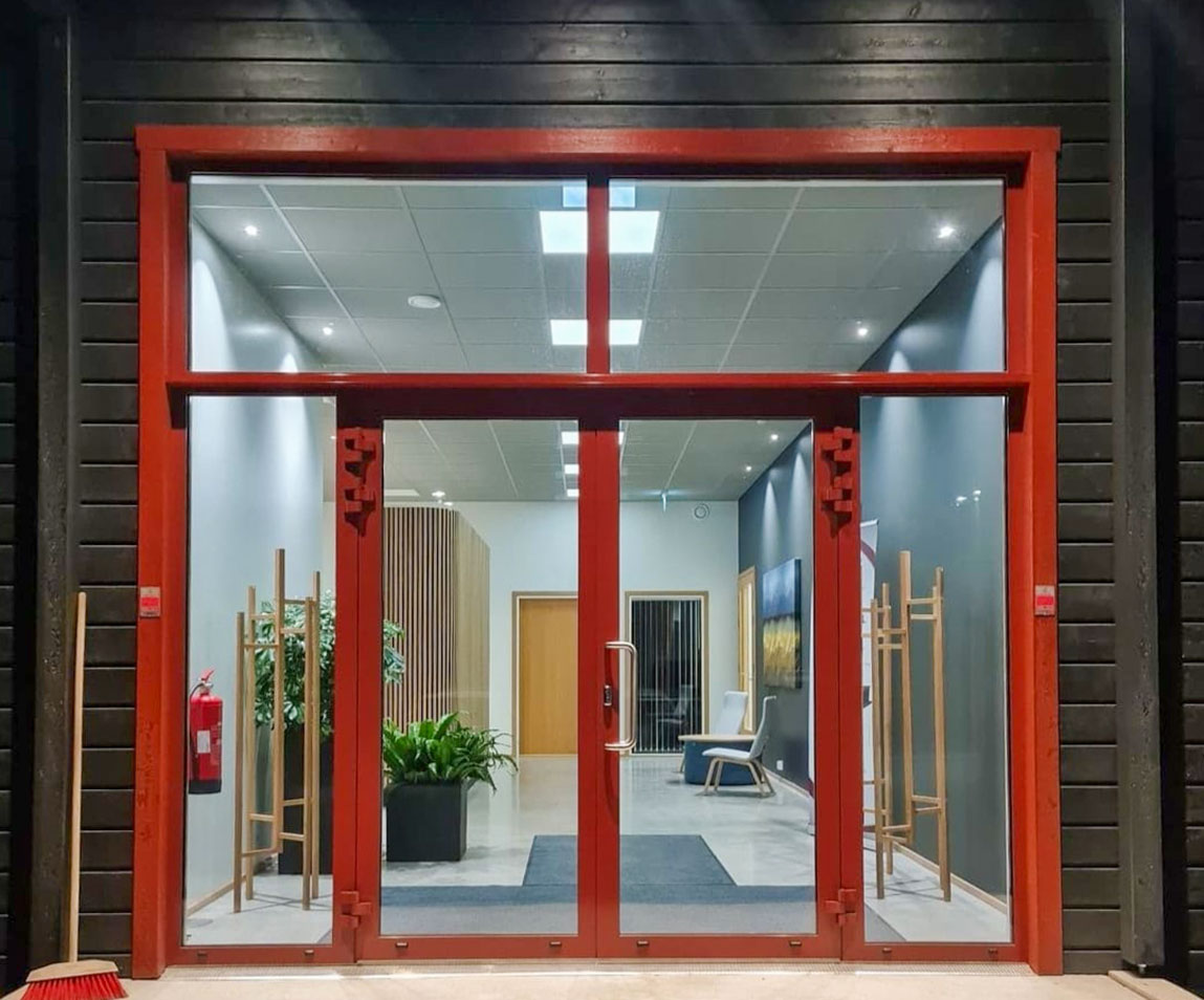 Large red metal doors with glass
